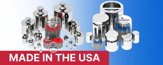 A collection of shiny stainless steel calibration weights of various sizes arranged in groups on a gradient blue and white background. Some weights have red or blue protective cases with the Troemner logo. A red banner at the bottom reads 'MADE IN THE USA,' highlighting their American origin and precision manufacturing.